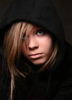 Portrait of the young girl in a black hood