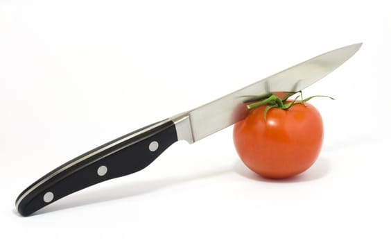 Knife and tomato isolated on white
