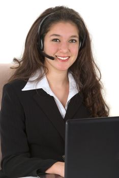 Beautiful professionally dressed young businesswoman with her headset and computer