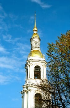 Bell tower with golden cupola, clock and broach 