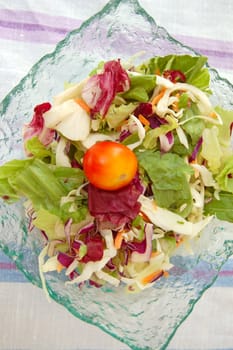 Bowl with fresh mixed salad. Raw food background.