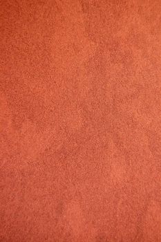 Dark brown recycled speckled cardboard paper detail. Background texture.