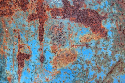 Metal texture with peeled blue paint and rust. Abstract background.