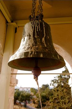 Rusty bell inside an old church tower in a village in Greece.