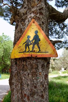 Rusty traffic control warning sign for school children. Speed restriction.