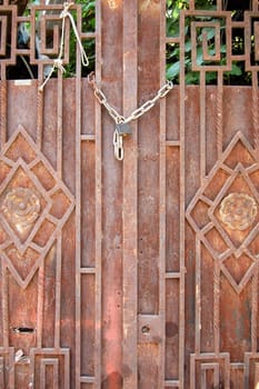 Rusty vintage door with floral pattern. Abstract background texture.