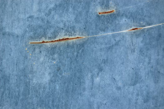 Rusty metal with blue scratched paint. Abstract background texture.