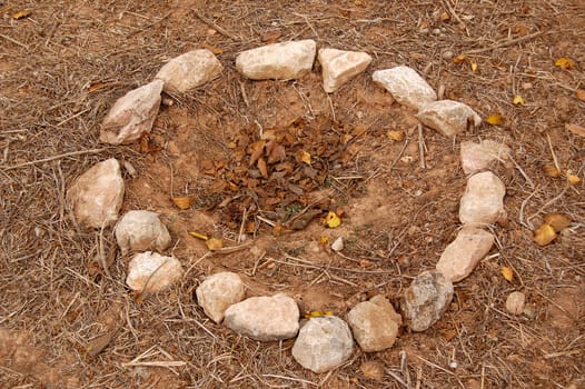 Campfire stone circle in a forest. Abstract background.