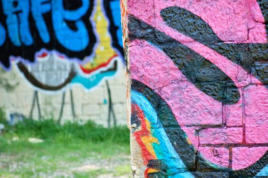 Stone wall surface covered with graffiti tags. Urban background.