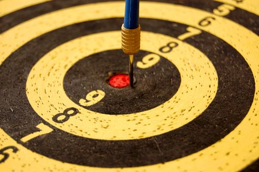 Dartboard target and dart arrow. Abstract sports background.