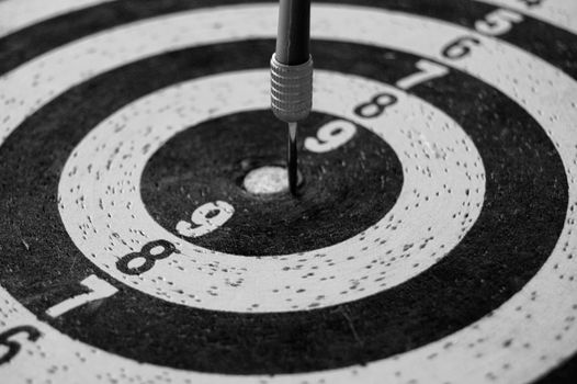 Target with dart arrow abstract sports background. Black and white.