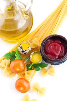 Pasta ingredients with cherry tomato, eggs, ketchup and greens
