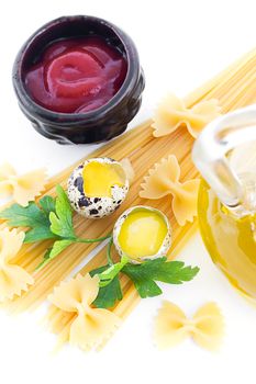 Pasta ingredients with olive oil, eggs, greens and ketchup