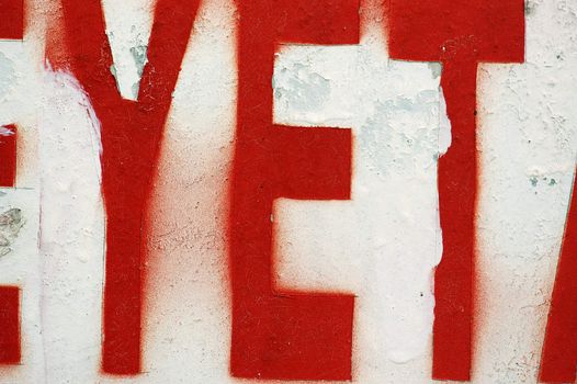 Type stencil on weathered surface. Abstract background.