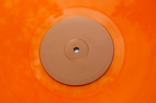 Colored orange vinyl record detail. Abstract background.