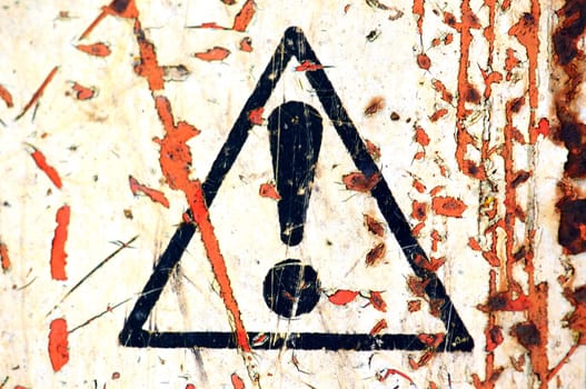 Weathered warning sign background on rusty metal surface.