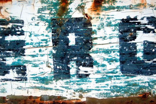 Type stencil on weathered and rusty metal surface. Abstract background texture.