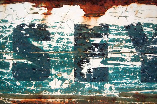 Type stencil on rusty metal surface. Abstract background texture.