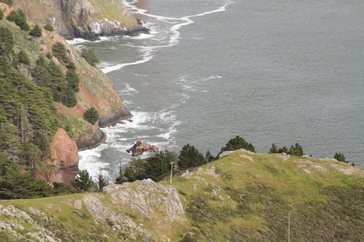 Coastline with green hills by the ocean