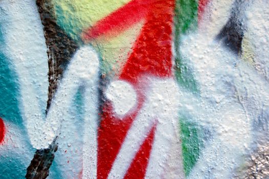 Detail of a wall covered with graffiti.