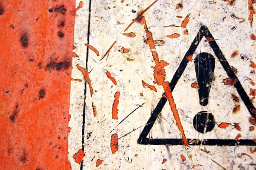 Rusty metal surface and weathered warning sign background.