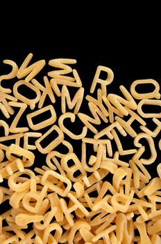 Alphabet soup pasta detail. Children's food background.