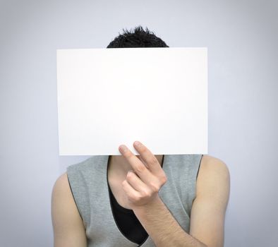 Young man holding a blank card