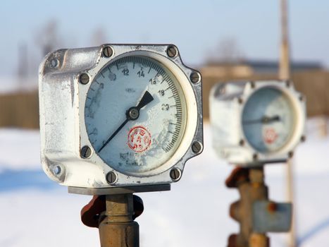 Old gas manometer in the winter in hoarfrost