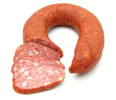 Tasty sausage is curtailed by a ring lies on a white background