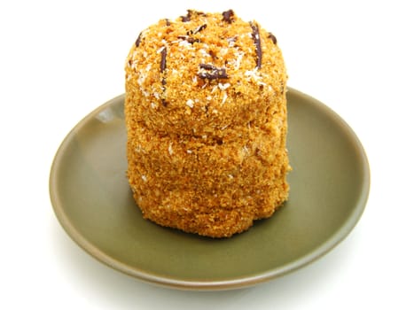 Honey cake with chocolate on a white background
