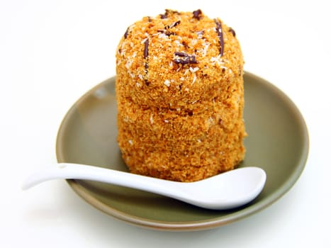 Honey cake with chocolate on a white background