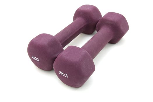 Two two kilogram dumbbells of crimson color separately on the white
