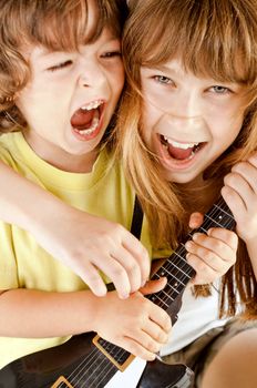 Two sweet little kids playing a guitar and singing