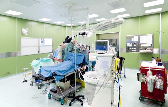 Medical team performing surgery in operative room