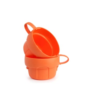 Pair of orange plastic cups on white background. Isolated with clipping path