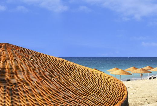 Sand beach view behind umbrella