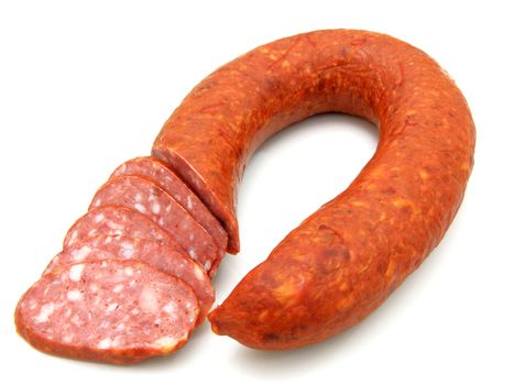 Tasty sausage is curtailed by a ring lies on a white background