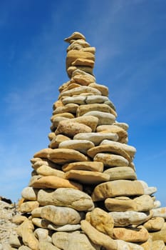 Pile of pebble as the tower against the background of sky