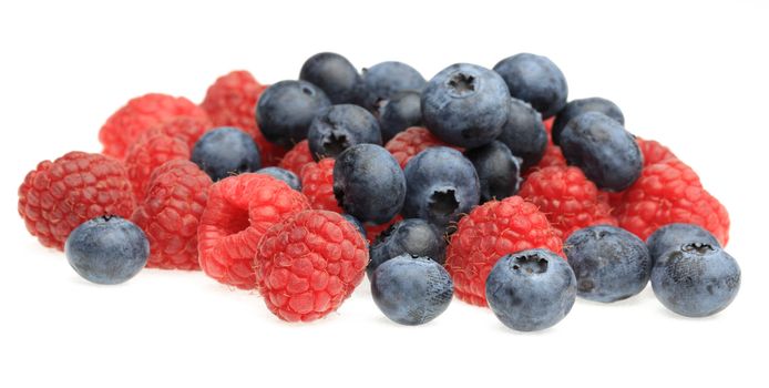 Image of a heap of berry fruits photographed in a studio against a white background.