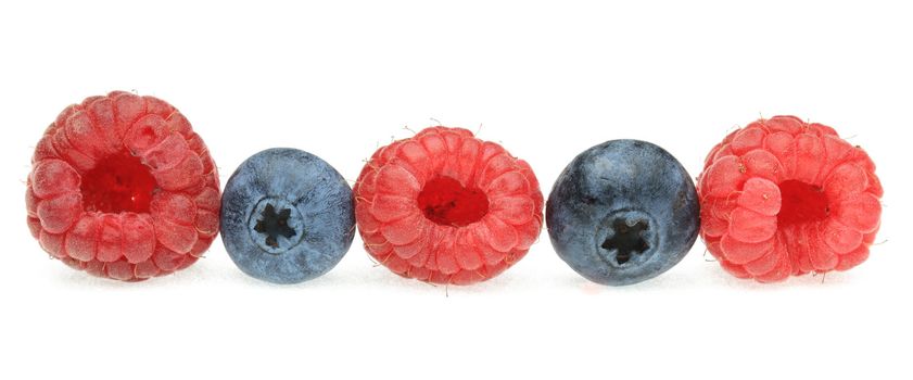Image of a raw of berry fruits photographed in a studio against a white background.