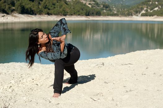 Hispanic woman enjoying early morning yoga exercises in a beautiful natural setting