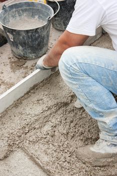 Mason building a screed coat cement