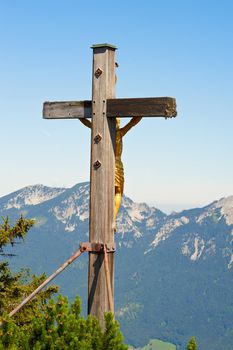 Gold crucifix on top of a mountain Predigtstuhl, Germany