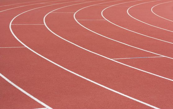 Athletics track with its lane, white lines and turn