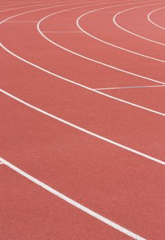 Athletics track with its lane, white lines and turn