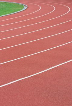 Athletics track with its lane, white lines and turn