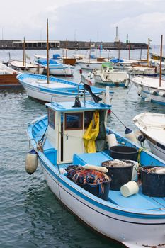 Fishing boats and sailboat in the port of Capri