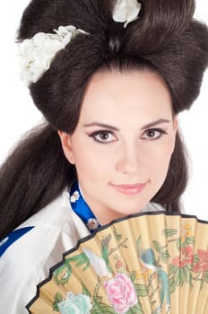 Portrait of the girl of the Asian appearance with a make-up under the geisha on a white background