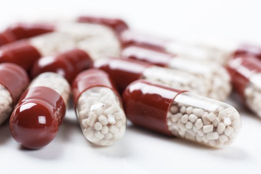 Macro view of few pills on a white background