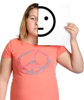 A serious girl is holding up a piece of white paper with a straight face, isolated against a white background.